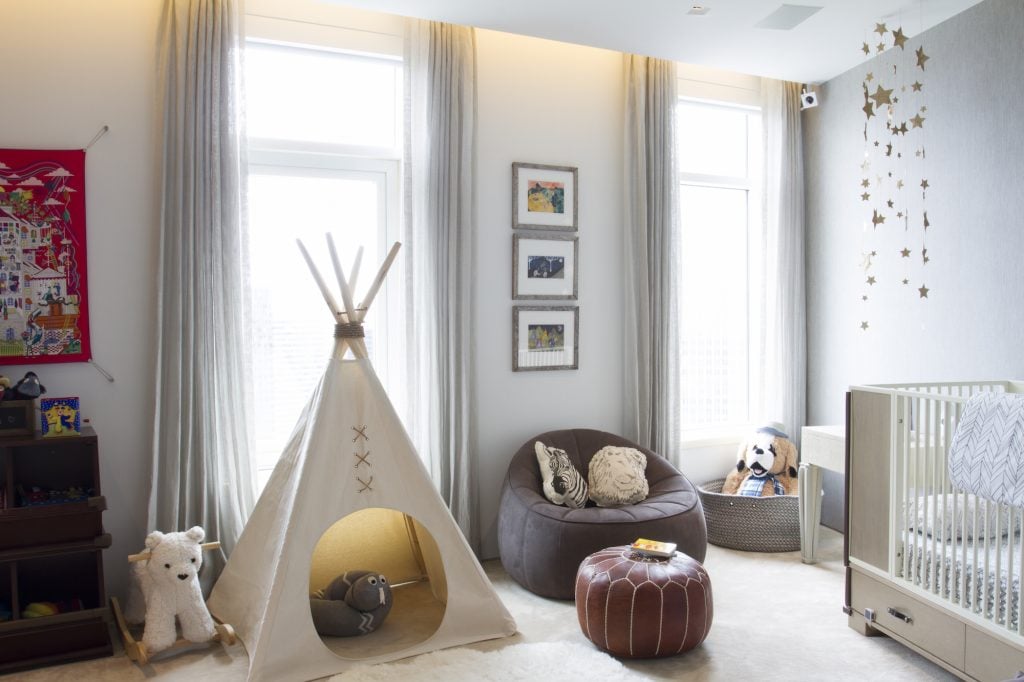 A playful baby boy nursery complete with teepee, stuffed animals & creative shelving. Designed by Havenly.