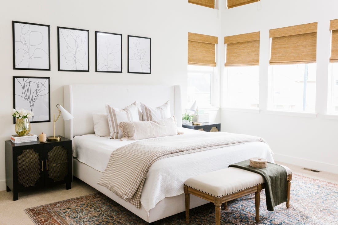 white high-contrast guest bedroom with bench