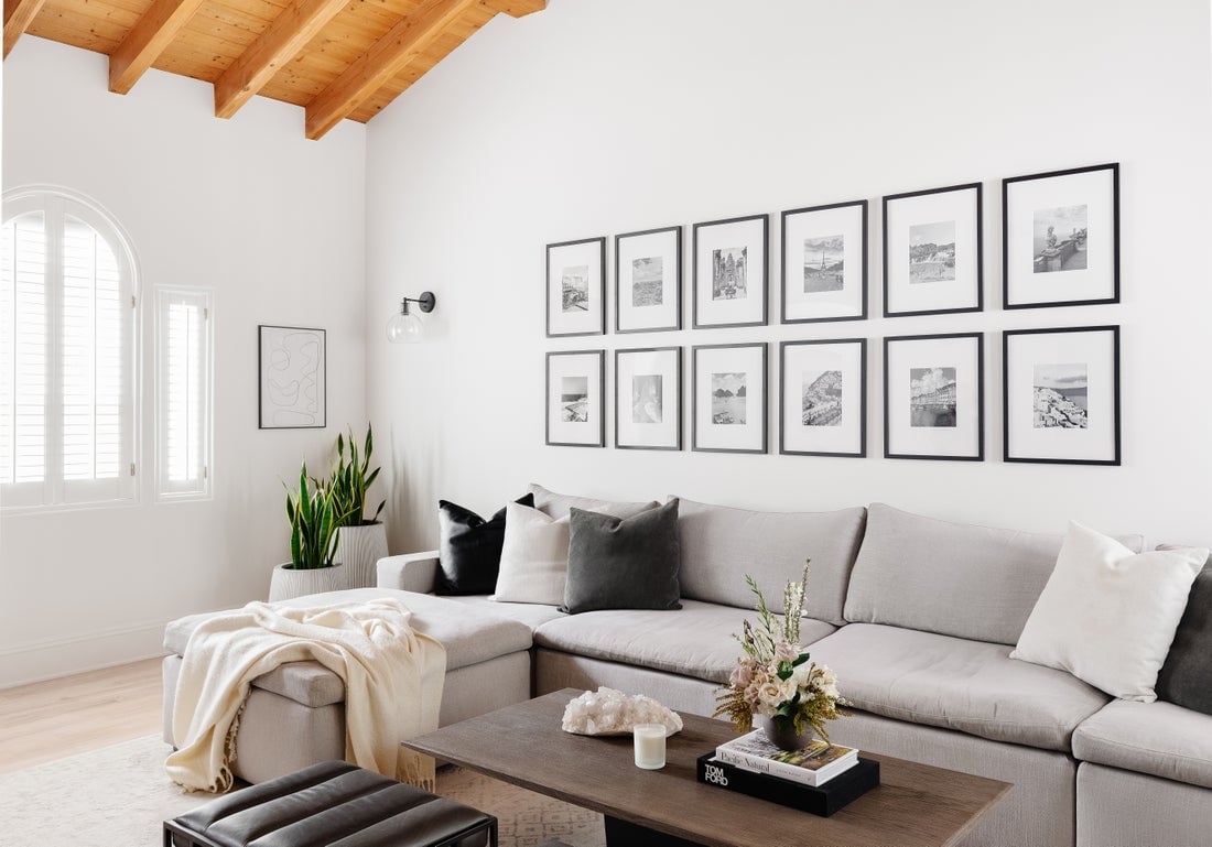 Sectional sofa with black and white gallery wall