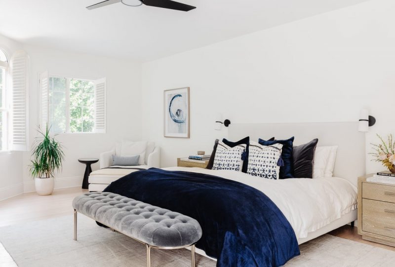 blue grey and ivory bedroom with bench
