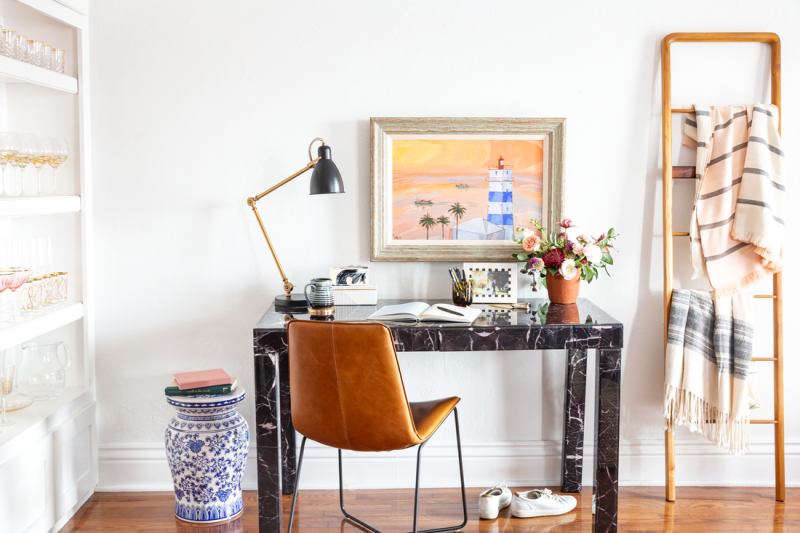 eclectic office with marble desk and leather chair