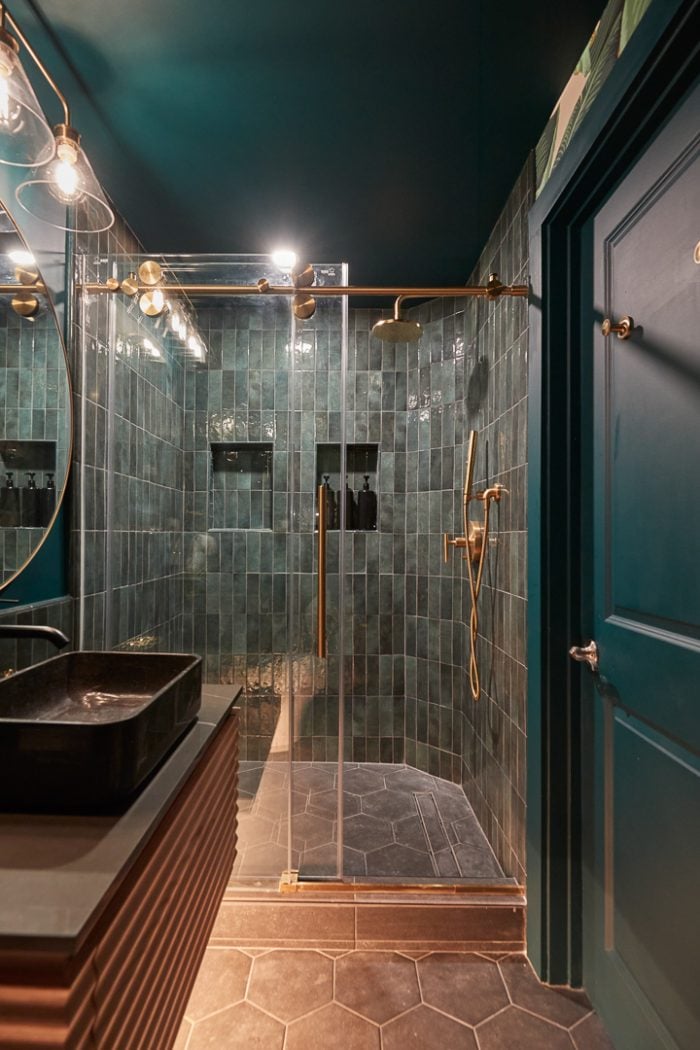 deep teal vertical tile in shower with teal walls