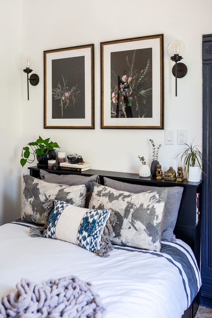 moody bedroom with black bed and artwork