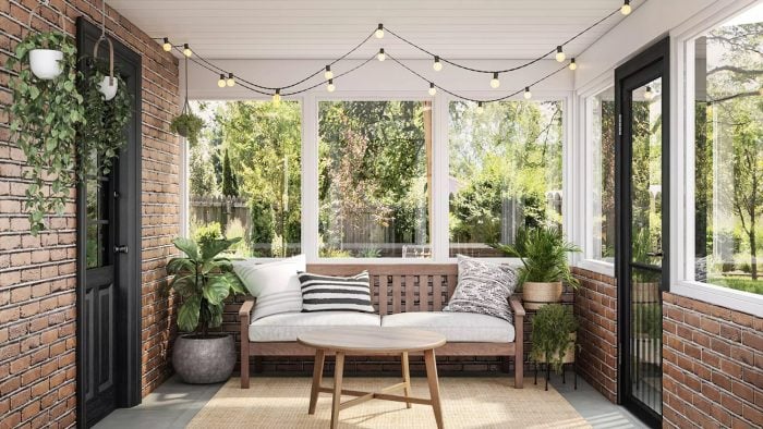 wooden outdoor sofa with plants and string lights