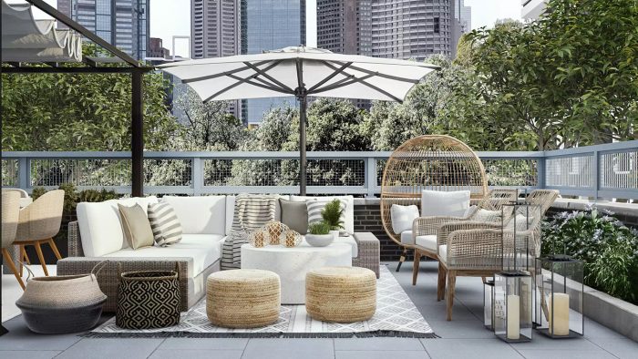 wicker patio sectional on boho rug with outdoor umbrella