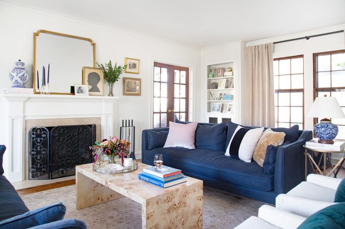 small living room with blue velvet sofa and burlwood coffee table