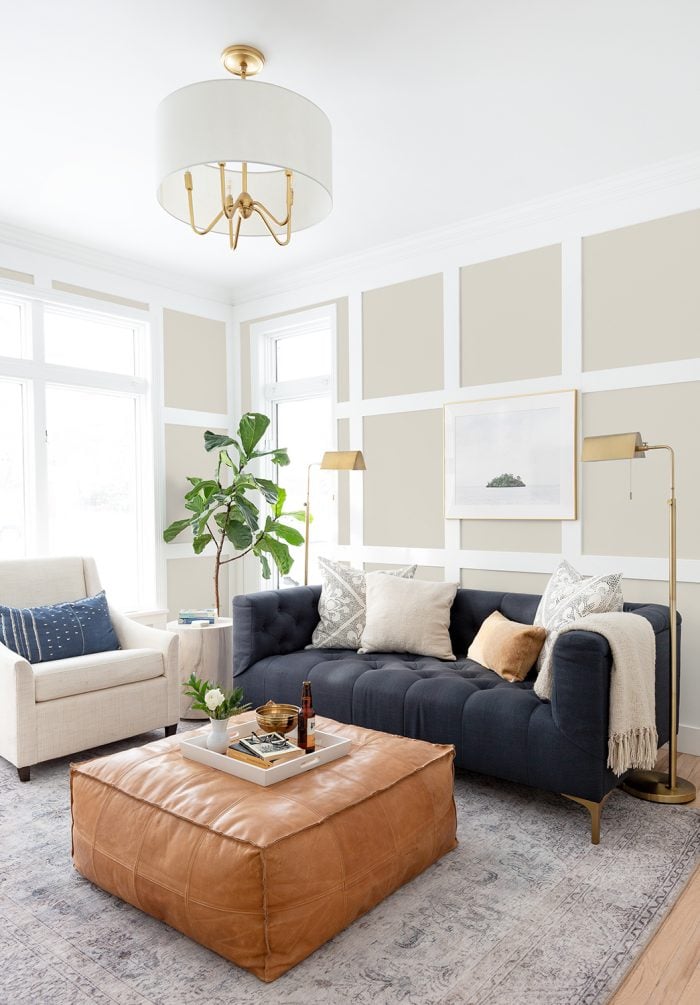 Benjamin Moore Pale Oak in classic living room with navy sofa