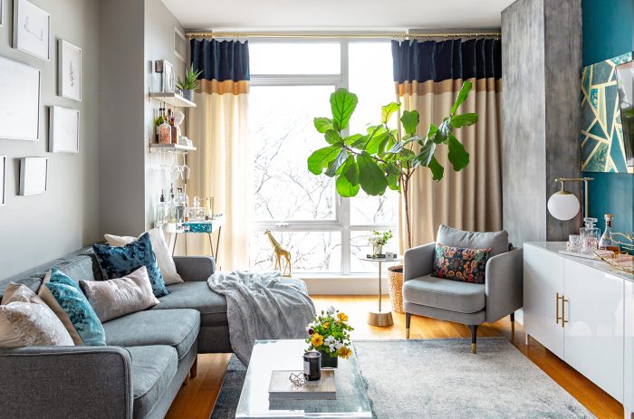 apartment living room with gray sectional and modern curtains