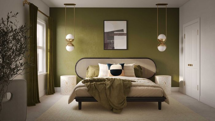 cane bed with modern pendants and green accent wall