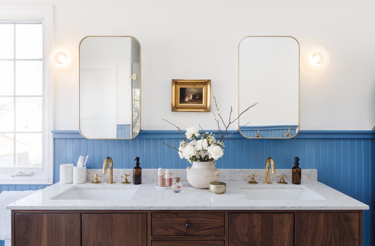 blue bathroom with wood vanity